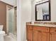 Bathroom featuring wood cabinets, granite counters, and a glass-enclosed shower at 4524 Southampton Ct # 4524, Tampa, FL 33618