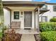 Inviting front porch with seating and a view of the landscaped garden at 4524 Southampton Ct # 4524, Tampa, FL 33618
