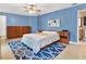 Comfortable main bedroom with blue walls and wood bedroom furniture at 4524 Southampton Ct # 4524, Tampa, FL 33618
