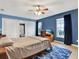 Comfortable main bedroom with blue walls, ceiling fan, and natural light from windows at 4524 Southampton Ct # 4524, Tampa, FL 33618