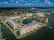 Gorgeous aerial view of the condo complex with a lake, tennis courts and a pool at 4525 Cove Cir # 705, St Petersburg, FL 33708