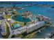 Stunning aerial view of the condo complex with water views and amenities like a pool and tennis courts at 4525 Cove Cir # 705, St Petersburg, FL 33708
