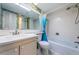 Bathroom features a shower and tub combination and white tile throughout at 4525 Cove Cir # 705, St Petersburg, FL 33708