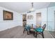 Dining area with wood floors, mirrored wall, kitchen access and seating for two at 4525 Cove Cir # 705, St Petersburg, FL 33708