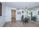 Bright dining area with wood floors, mirrored wall, and seating for two at 4525 Cove Cir # 705, St Petersburg, FL 33708