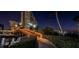 Picturesque night view of the condo buildings with a bridge over the water and lush landscaping at 4525 Cove Cir # 705, St Petersburg, FL 33708