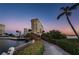 Picturesque view of the condo buildings with a bridge over the water and lush landscaping at 4525 Cove Cir # 705, St Petersburg, FL 33708
