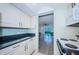 Cozy kitchen view highlighting white cabinetry and an open view to the living area at 4525 Cove Cir # 705, St Petersburg, FL 33708