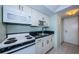 Well-equipped kitchen featuring white appliances, countertops, and tile backsplash at 4525 Cove Cir # 705, St Petersburg, FL 33708