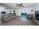 Living room with wood floors, ceiling fan and access to the lanai at 4525 Cove Cir # 705, St Petersburg, FL 33708