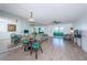 Spacious living room area featuring wood floors and a mirrored wall at 4525 Cove Cir # 705, St Petersburg, FL 33708