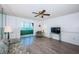 Living room with wood floors, ceiling fan and access to the lanai at 4525 Cove Cir # 705, St Petersburg, FL 33708