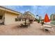 Inviting outdoor seating area featuring tiki hut and picnic tables at 4525 Cove Cir # 705, St Petersburg, FL 33708