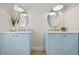 Double vanity bathroom features light blue cabinets, modern lighting, and unique wall decor at 4568 40Th S St, St Petersburg, FL 33711