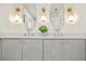 Contemporary bathroom with stylish vanity, double sinks, gold accents, and decorative lighting at 4568 40Th S St, St Petersburg, FL 33711