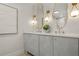 Elegant bathroom featuring double sinks, unique gold fixtures, and modern white cabinets at 4568 40Th S St, St Petersburg, FL 33711