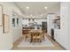 Bright dining area featuring modern lighting, a large window, and a glimpse into a kitchen at 4568 40Th S St, St Petersburg, FL 33711