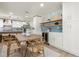 Dining area with stylish blue tile backsplash, wooden table and view into the modern kitchen at 4568 40Th S St, St Petersburg, FL 33711