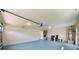 Large garage with an overhead door, utility sink, and water heater at 4568 40Th S St, St Petersburg, FL 33711