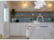 Kitchen featuring marble island, barstool seating, shelving, and modern lighting at 4568 40Th S St, St Petersburg, FL 33711