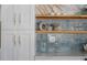 Close up of the white cabinets, shelving, and blue backsplash in the kitchen area at 4568 40Th S St, St Petersburg, FL 33711