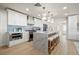Bright and modern kitchen with a large island, seating, stainless steel appliances, and white cabinetry at 4568 40Th S St, St Petersburg, FL 33711
