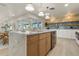 Modern kitchen with a large island, light wood cabinets, stainless steel appliances, and custom lighting at 4568 40Th S St, St Petersburg, FL 33711