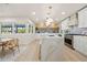 Open concept kitchen with marble island, sleek appliances, and dining area view at 4568 40Th S St, St Petersburg, FL 33711