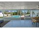 Open patio with tiled floor, dining table set, and views of the private in-ground swimming pool at 4568 40Th S St, St Petersburg, FL 33711