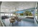 Inviting patio with outdoor dining set and ceiling fan, overlooking the private swimming pool and backyard at 4568 40Th S St, St Petersburg, FL 33711