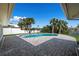 A backyard pool with brick paver patio surrounded by manicured landscaping at 4568 40Th S St, St Petersburg, FL 33711