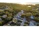 Panoramic aerial view of a neighborhood with lush greenery, pool and water views at 476 Rebstock Blvd, Palm Harbor, FL 34683