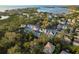 Stunning aerial view of waterfront homes, surrounded by lush greenery and serene waterways at 476 Rebstock Blvd, Palm Harbor, FL 34683