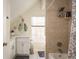 Bright bathroom featuring tiled shower and tub combination, a vanity and ample natural light at 476 Rebstock Blvd, Palm Harbor, FL 34683