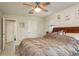 Bedroom with a ceiling fan and a wooden bed frame with a neutral colored comforter at 476 Rebstock Blvd, Palm Harbor, FL 34683