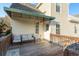Outdoor deck with neutral furniture, wooden railings, and exterior door at 476 Rebstock Blvd, Palm Harbor, FL 34683