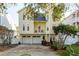 Charming two-story yellow home with a balcony and two-car garage at 476 Rebstock Blvd, Palm Harbor, FL 34683