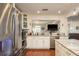 Modern kitchen with stainless steel appliances, marble countertops, and open layout to the living room at 476 Rebstock Blvd, Palm Harbor, FL 34683
