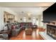Cozy living room with a large television, leather furniture, and open layout to kitchen at 476 Rebstock Blvd, Palm Harbor, FL 34683