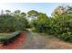 Landscaped path lined with lush greenery and mulch at 476 Rebstock Blvd, Palm Harbor, FL 34683