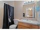 Bathroom with sink, toilet, mirror, vanity and shower with black curtain at 5162 Sunridge Palms Dr # 5162, Tampa, FL 33617