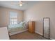 Bedroom featuring a twin bed, ceiling fan and window with natural light and neutral wall paint at 5162 Sunridge Palms Dr # 5162, Tampa, FL 33617