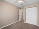 A basic bedroom with neutral color palette, closet and doorway with carpeted floor at 5162 Sunridge Palms Dr # 5162, Tampa, FL 33617