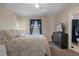 Inviting bedroom featuring a bed, dresser with TV, and an ensuite bathroom at 5162 Sunridge Palms Dr # 5162, Tampa, FL 33617