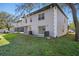 The condo building features a back patio, lawn, screened-in lanai, and neutral paint at 5162 Sunridge Palms Dr # 5162, Tampa, FL 33617