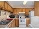 Well-equipped kitchen with oak cabinets, ample counter space, and essential appliances at 5162 Sunridge Palms Dr # 5162, Tampa, FL 33617