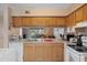 Bright kitchen with a view of the living area and outdoors, oak cabinets, and ample countertop space at 5162 Sunridge Palms Dr # 5162, Tampa, FL 33617