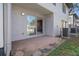 Back patio with sliding glass doors leading to the residence and adjacent to the outside entrance door at 5162 Sunridge Palms Dr # 5162, Tampa, FL 33617