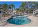The community pool has brick pavers, a blue tile trim, and white fencing at 5162 Sunridge Palms Dr # 5162, Tampa, FL 33617