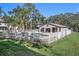 Community pool, fenced in and features poolhouse, ample seating, and mature trees at 5162 Sunridge Palms Dr # 5162, Tampa, FL 33617
